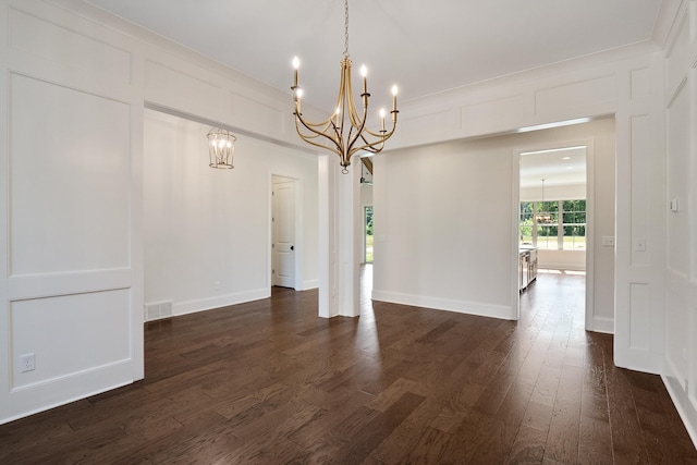 unfurnished dining area with dark wood-type flooring and a notable chandelier