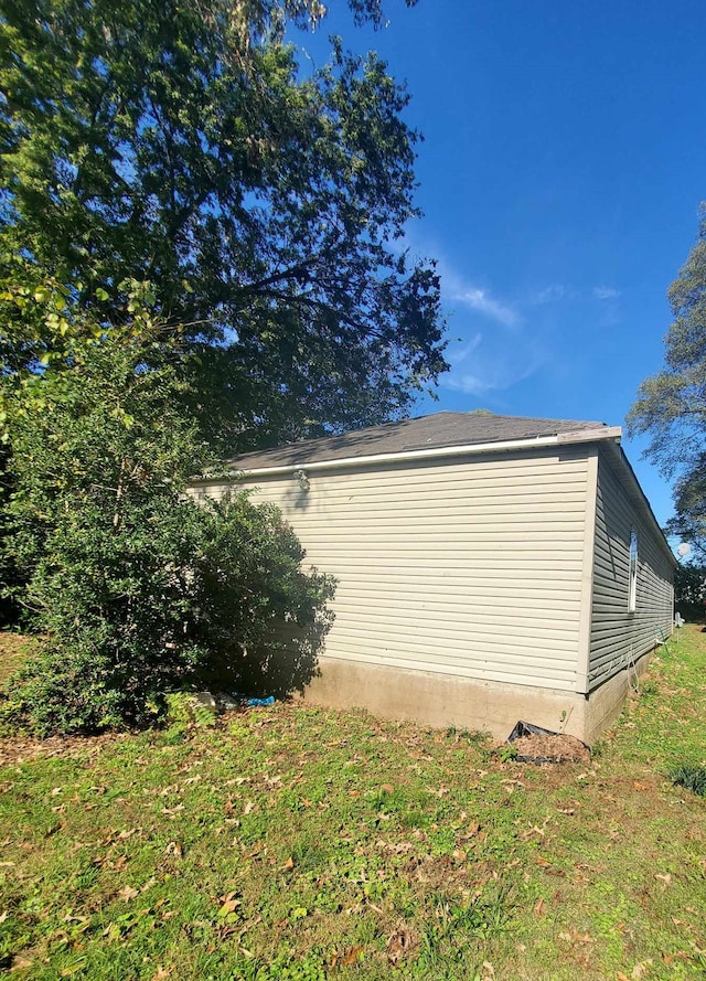 view of side of property with a lawn