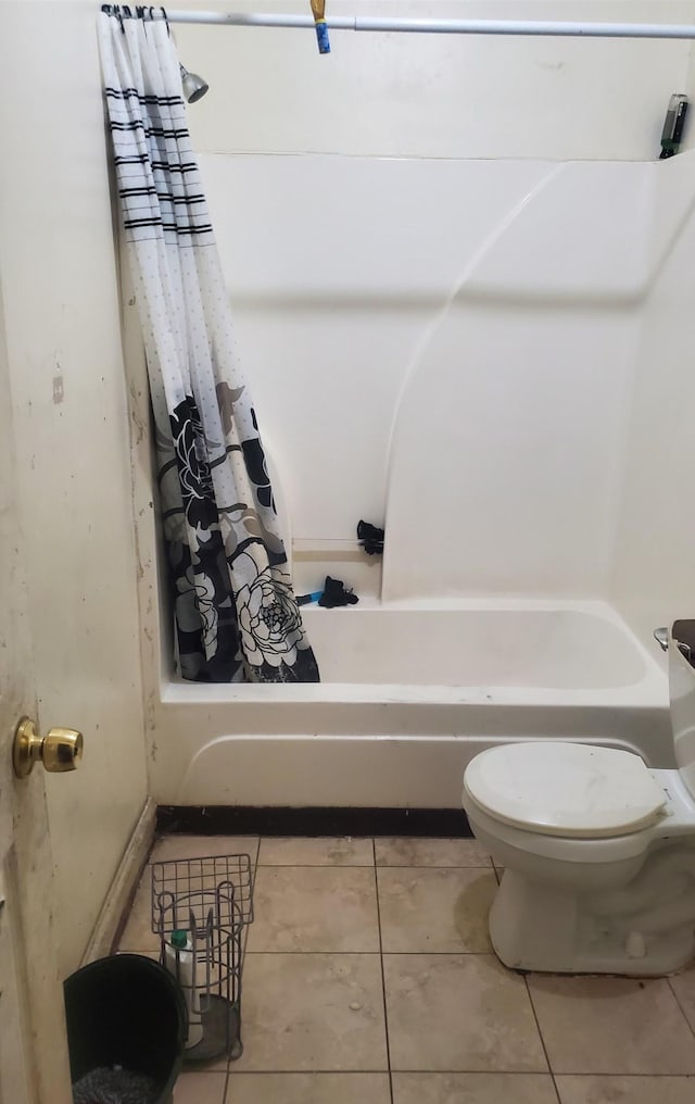 bathroom with tile patterned flooring, toilet, and shower / bathtub combination with curtain