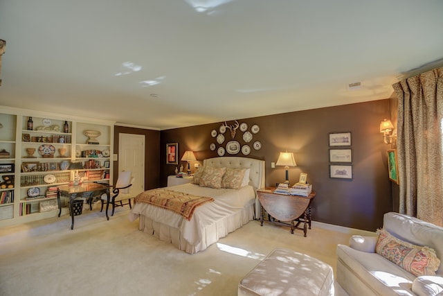 bedroom featuring crown molding and light carpet