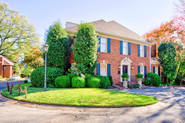 colonial home with a front yard