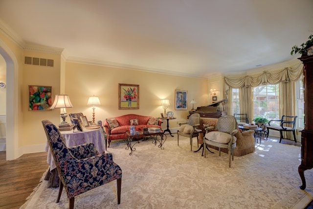 living room with ornamental molding and light hardwood / wood-style flooring