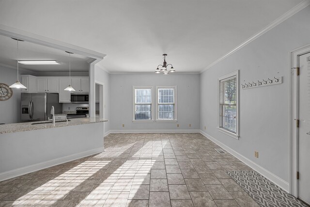 6 Laura Ln, Iuka, MS 38852 - kitchen featuring crown molding, light stone countertops, white cabinetry, stainless steel appliances, and a chandelier