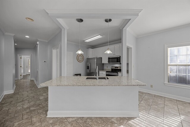6 Laura Ln, Iuka, MS 38852 - kitchen featuring ornamental molding, stainless steel appliances, decorative light fixtures, white cabinetry, and an island with sink