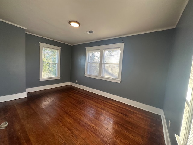 spare room with dark hardwood / wood-style floors and ornamental molding