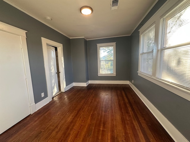 spare room with dark hardwood / wood-style flooring and ornamental molding