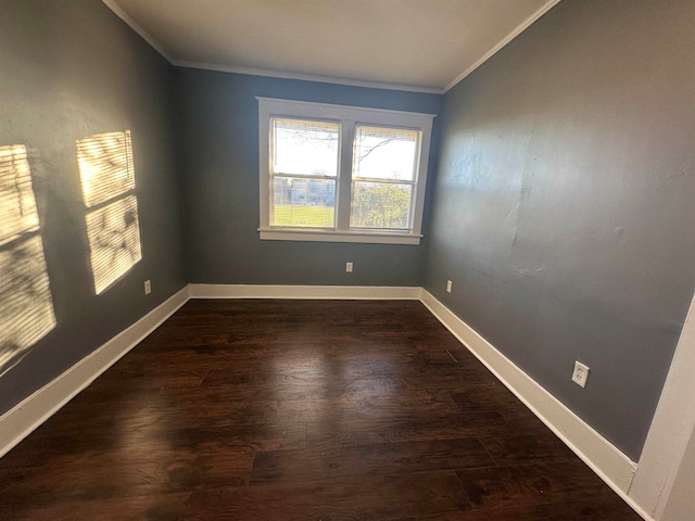 unfurnished room featuring dark hardwood / wood-style flooring and ornamental molding