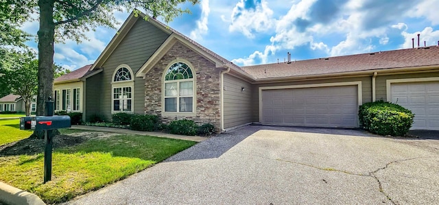 view of front property featuring a garage and a front lawn