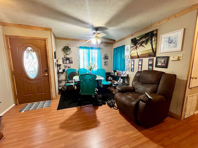 office space featuring ceiling fan, plenty of natural light, wood-type flooring, and a textured ceiling