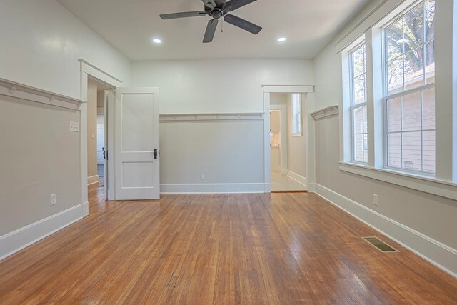 unfurnished bedroom featuring hardwood / wood-style floors, a closet, and ceiling fan