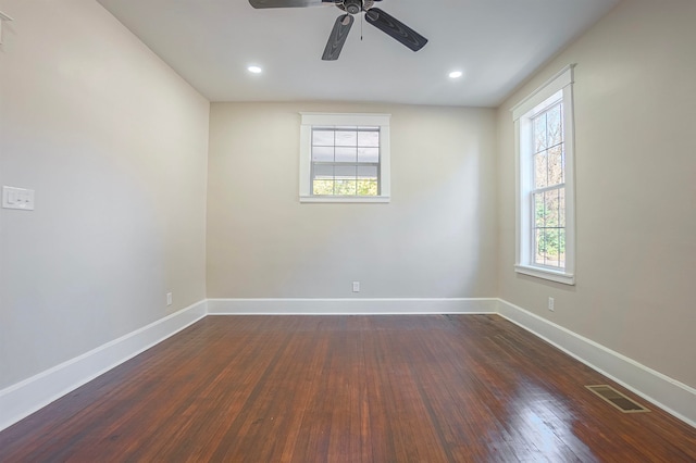 empty room featuring ceiling fan and dark wood-type flooring