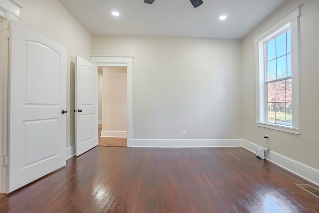 empty room featuring ceiling fan and dark wood-type flooring