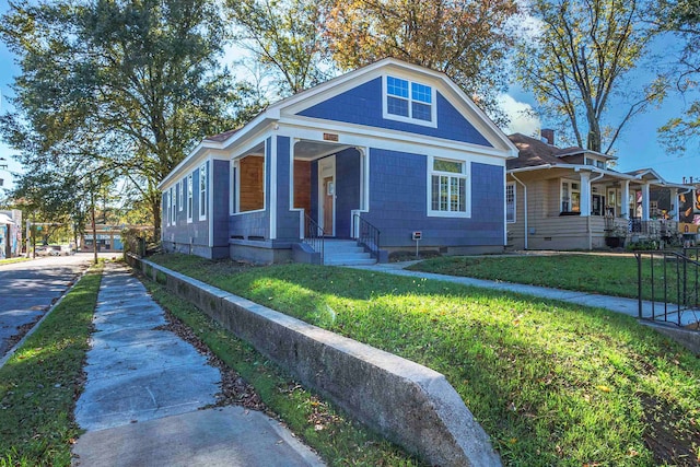 bungalow featuring a front yard