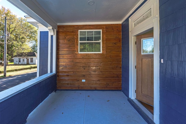 view of exterior entry with covered porch