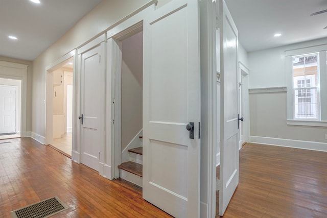 hallway with hardwood / wood-style flooring