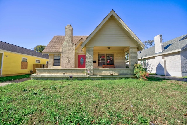 view of front of house with a front lawn and covered porch