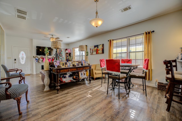 dining area with hardwood / wood-style flooring and ceiling fan