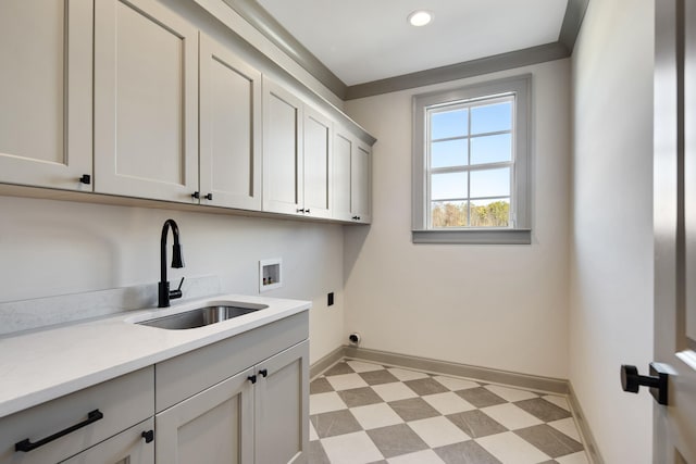 laundry room with electric dryer hookup, sink, cabinets, and washer hookup