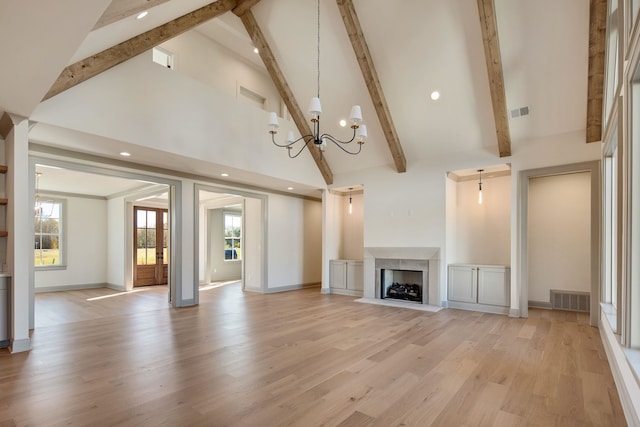 unfurnished living room with light hardwood / wood-style flooring, high vaulted ceiling, beamed ceiling, and an inviting chandelier