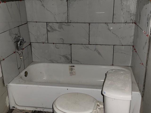 bathroom with toilet and a bathing tub