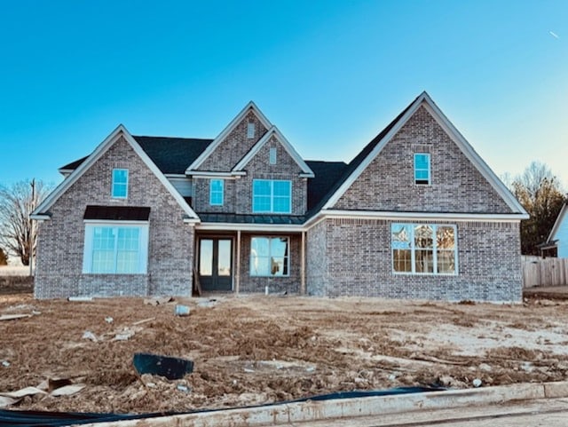 view of front of house with french doors and brick siding