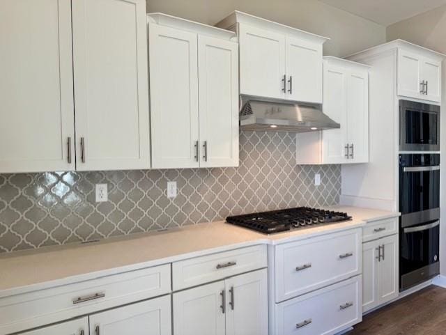 kitchen featuring light countertops, appliances with stainless steel finishes, white cabinetry, and under cabinet range hood