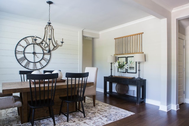 dining area featuring ornamental molding, a chandelier, baseboards, and dark wood-style flooring