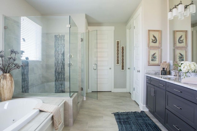 full bathroom featuring tile patterned flooring, vanity, baseboards, a tub with jets, and a stall shower