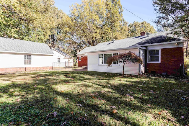 back of house with a yard