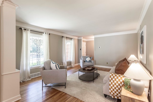 living room with wood-type flooring and crown molding