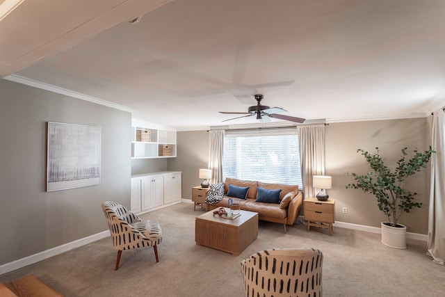 carpeted living room with ceiling fan and ornamental molding