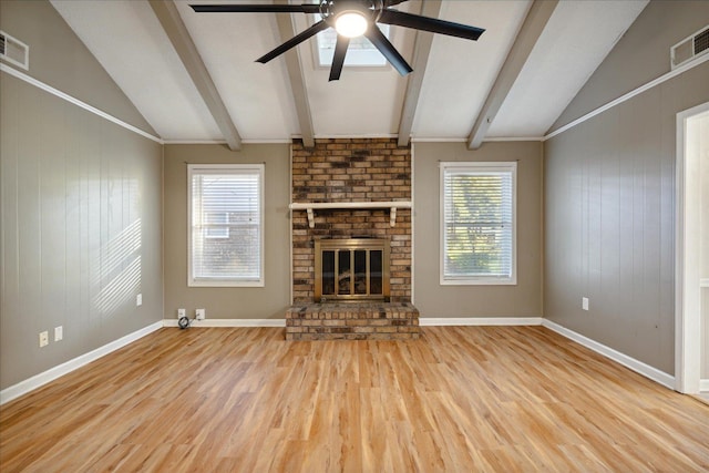 unfurnished living room with hardwood / wood-style floors, vaulted ceiling with beams, and plenty of natural light