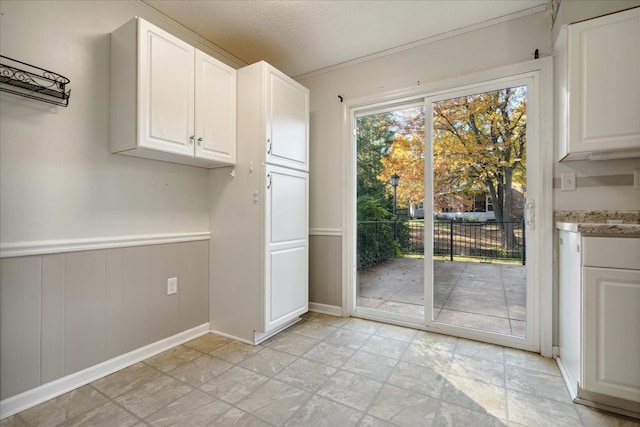 doorway to outside featuring a textured ceiling