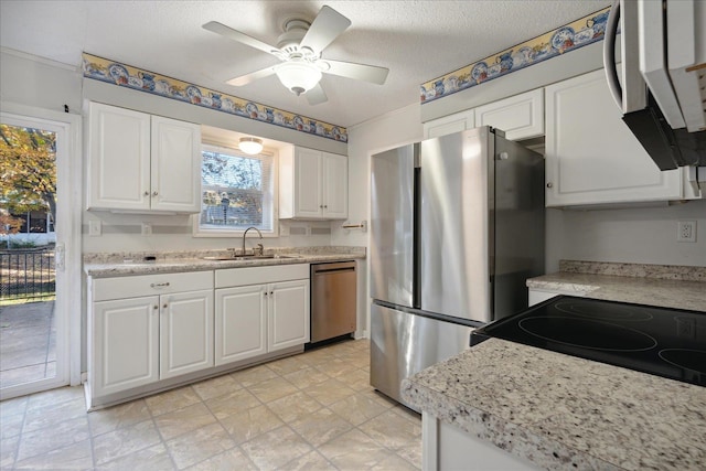 kitchen with sink, ceiling fan, a textured ceiling, white cabinetry, and stainless steel appliances