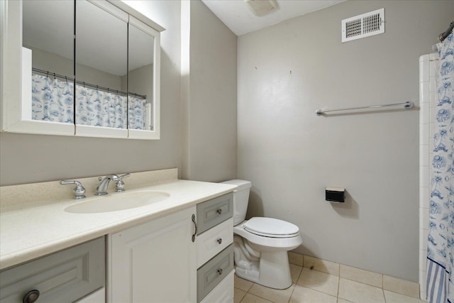 bathroom featuring toilet, a shower with curtain, vanity, and tile patterned floors