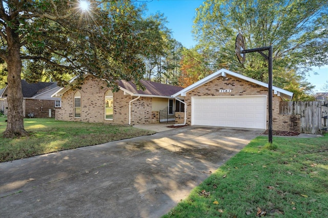 ranch-style house featuring a garage and a front lawn