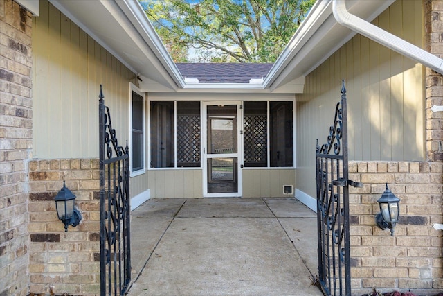 view of exterior entry with a patio area