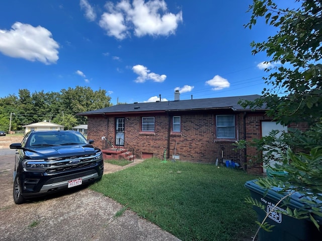 back of property featuring a yard