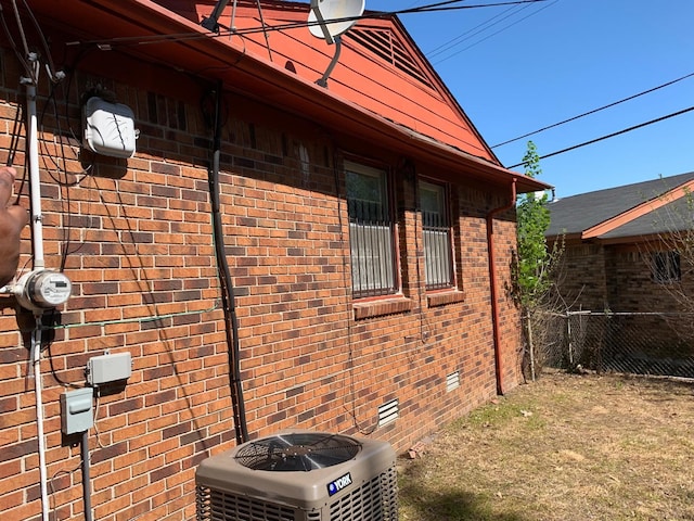 view of side of home with central AC