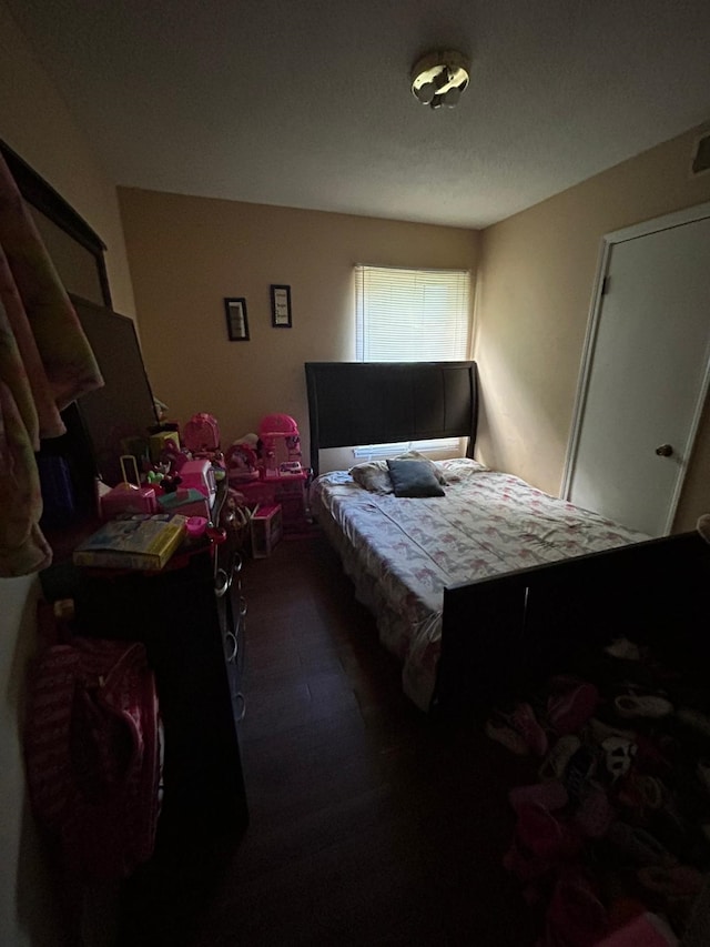 bedroom featuring dark wood-type flooring