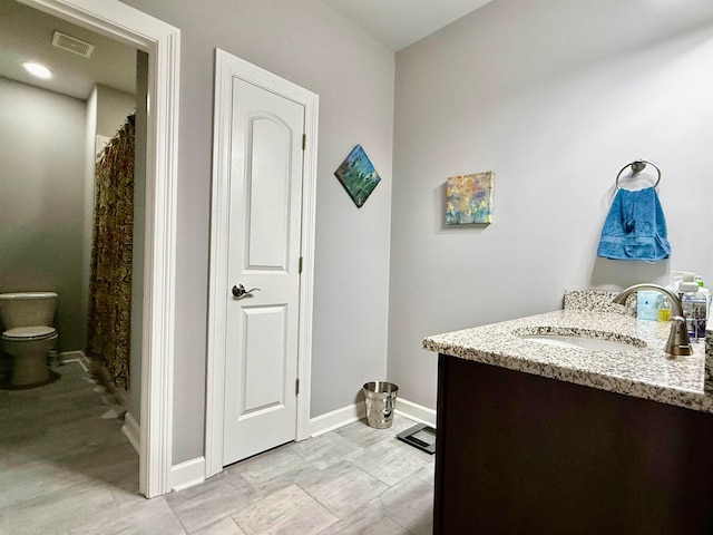 bathroom featuring vanity and toilet