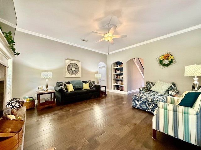 living room with dark hardwood / wood-style floors, ceiling fan, and ornamental molding