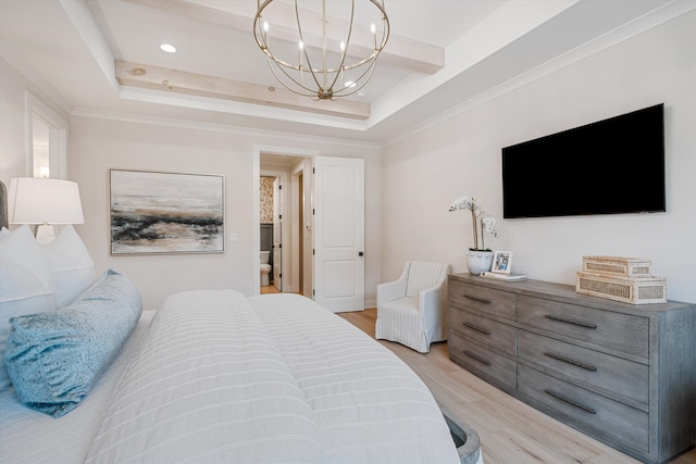 bedroom with a chandelier, light wood-type flooring, a tray ceiling, and crown molding