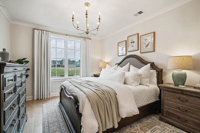 bedroom with light hardwood / wood-style floors, ornamental molding, and a chandelier