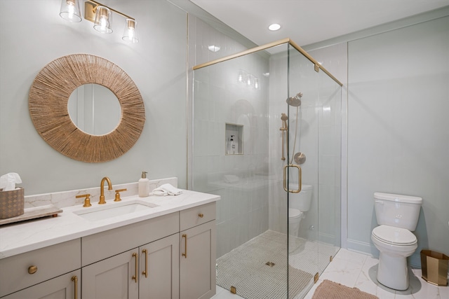 bathroom with vanity, toilet, and a shower with shower door