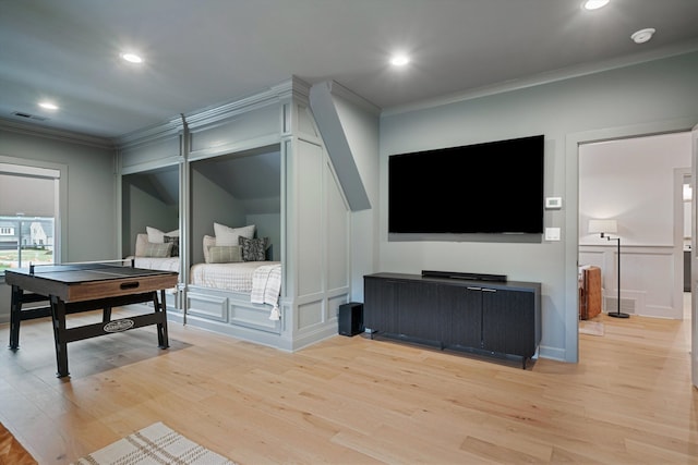 bedroom with light hardwood / wood-style flooring and crown molding