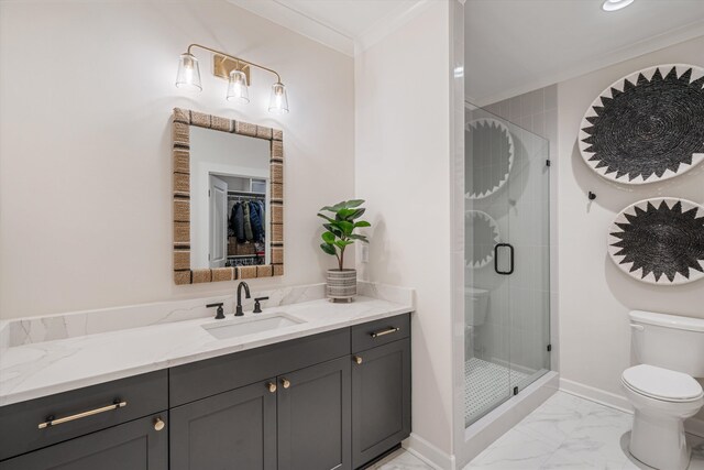 bathroom featuring toilet, vanity, crown molding, and a shower with shower door