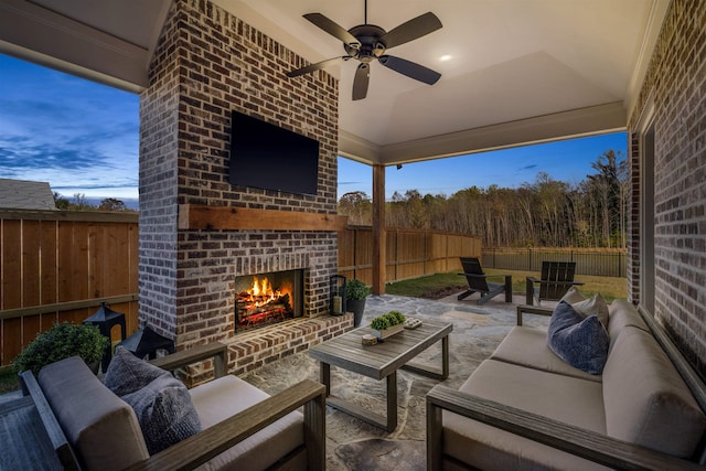 view of patio / terrace featuring an outdoor living space with a fireplace and ceiling fan