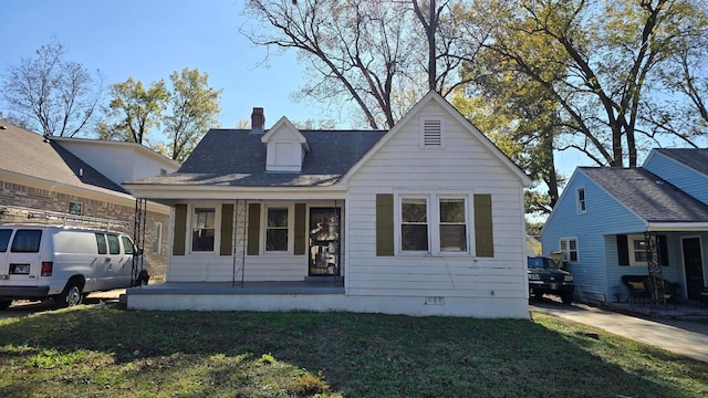 view of front of house with a front lawn and a porch