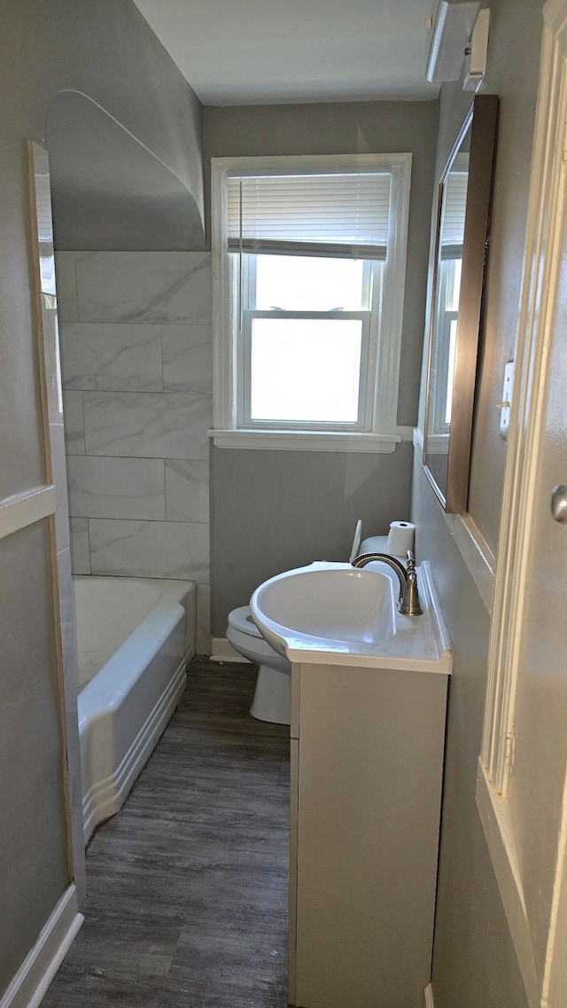 full bathroom with shower / bathing tub combination, hardwood / wood-style floors, vanity, and toilet